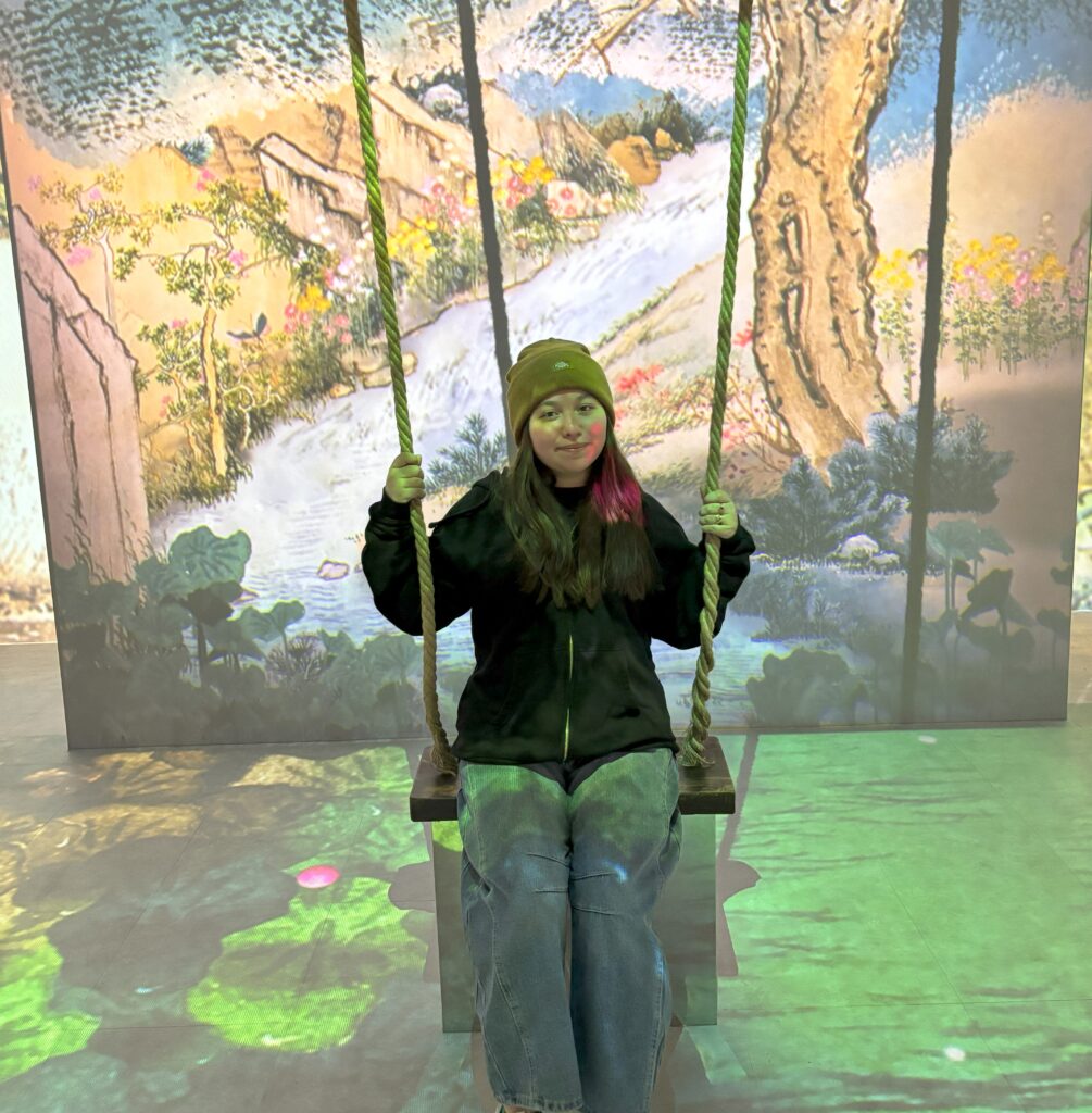 Girl swinging on a swing in a art museum